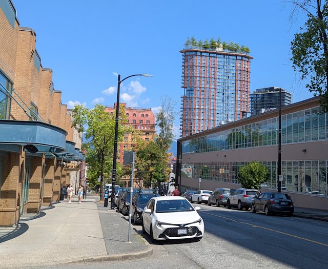 A tall building with a row of trees growing out of the top