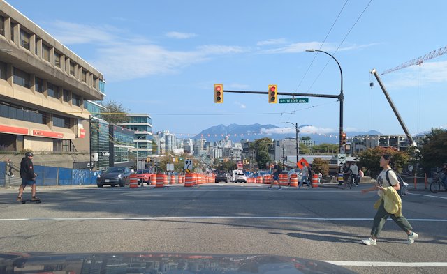 Intersection with a nice view of the water and people walking and bustling around