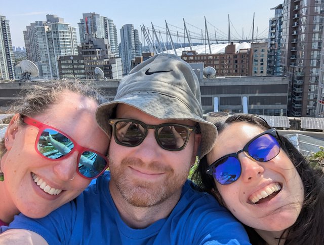 Selfie of three people with a nice city-scape in the background