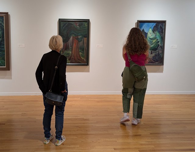 Stacey standing in front of art