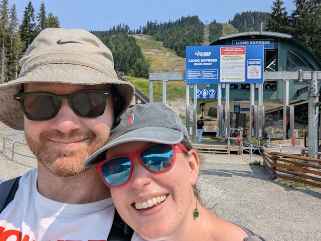 Josh and Stacey in front of the Lions Express ski lift behind them