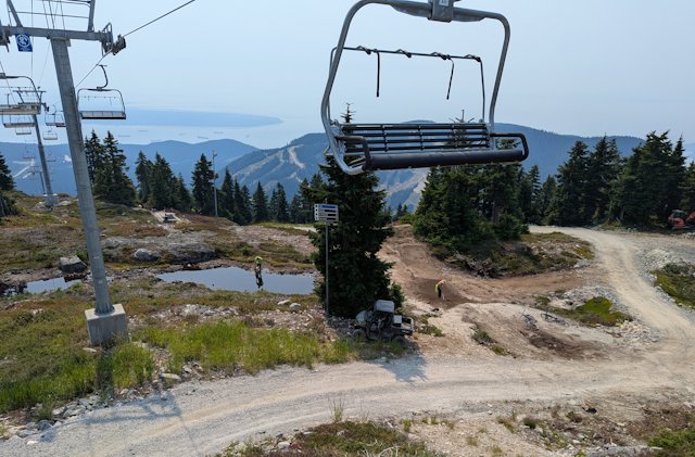 Riding down the lift from Cypress mountain two workers digging out a biking trail
