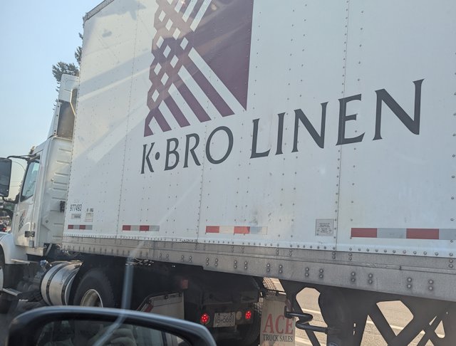 Side of a semi truck with K Bro Linen on the side