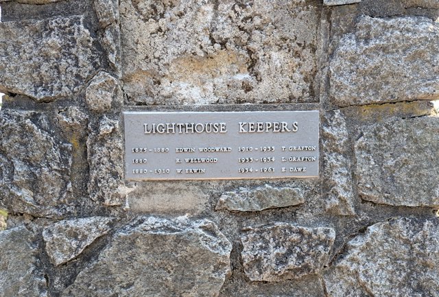 stone pillar with plaque recording the names and dates of lighthouse keepers