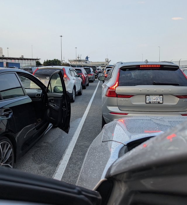 view between lanes of cars waiting to board the ferry