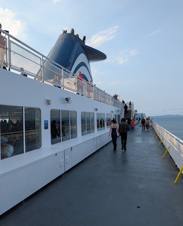 view along the promenade deck with stairs going up to the top deck