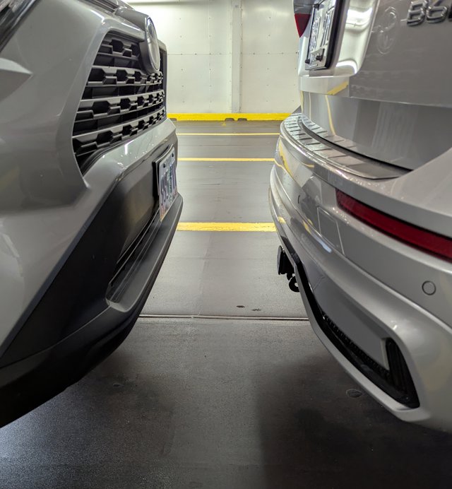 bumper of car about 12 inches from the next one packed in on the car deck