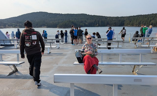 Stacey still seated on the top deck managing a slight smile