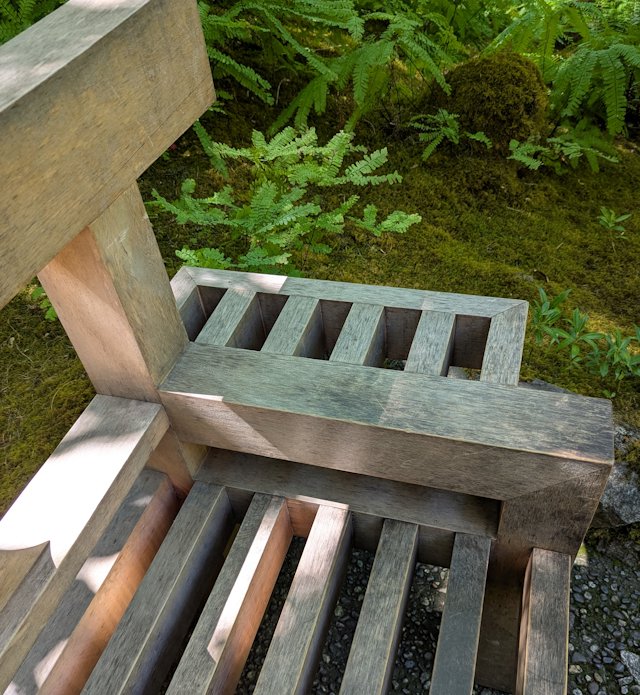 A solid bench with nice joinery in the shaded Japanese gardens
