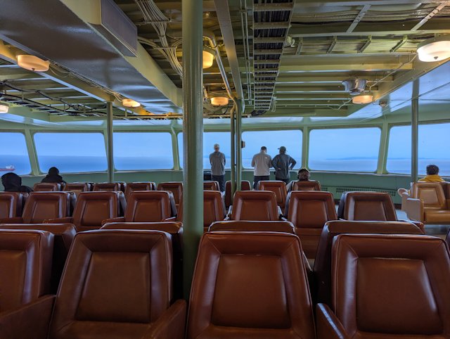 rows of leather seats with windows looking forward