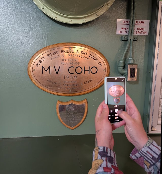 picture of stacey taking a picture of MV Coho sign