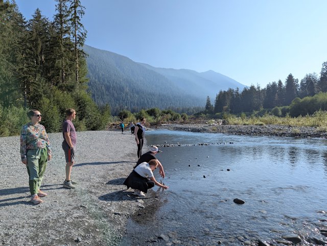 By the Hoh river, feeling how cold the water is and skipping rocks